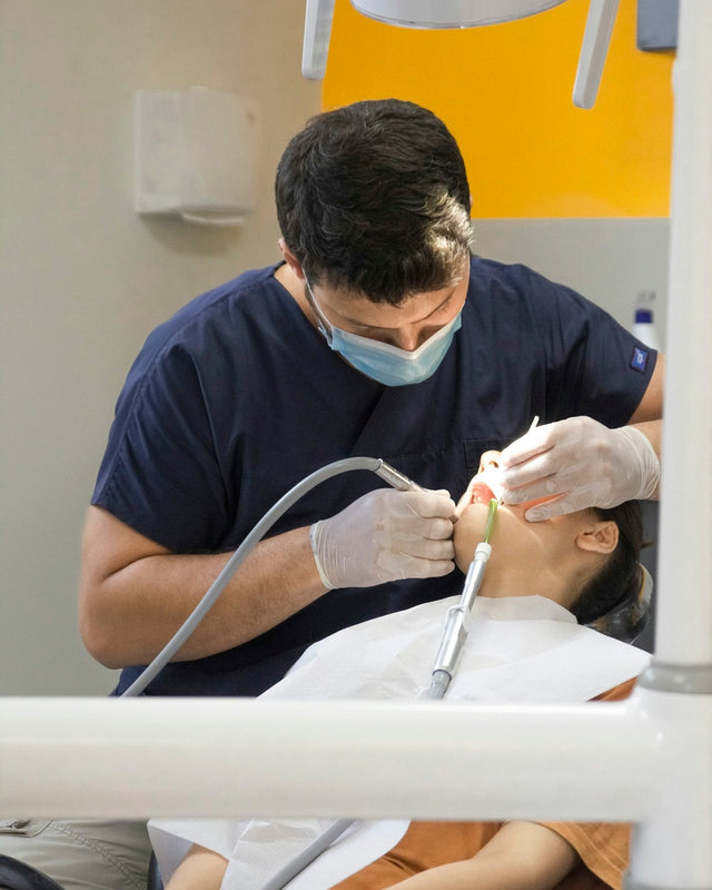Dental professional treating a patient in the chair