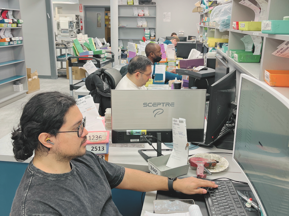 Lab technician designing a case at a CAD workstation