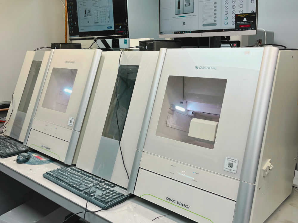 Row of dental milling machines at CAD/CAM stations